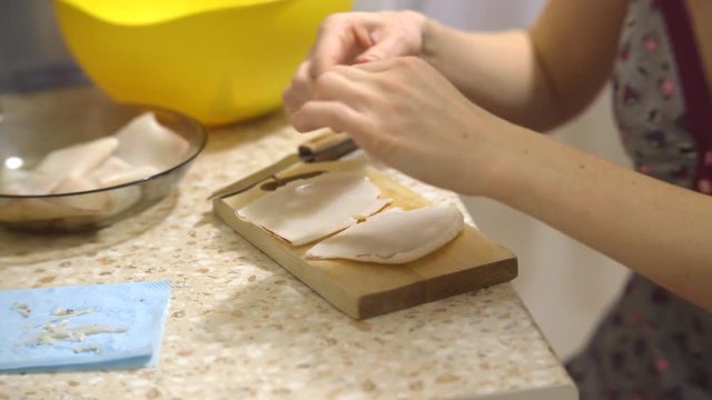 Cleaning and sliced boiled squid for a seafood salad on wooden cutting Board
