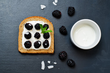 Healthy greek yogurt blackberry coconut flakes rye breakfast sandwich