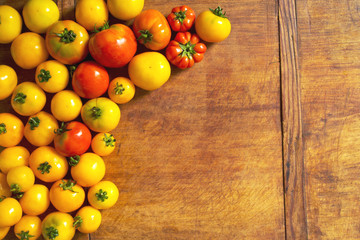 Ripe fresh tomatoes on wooden table with copy space
