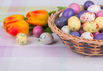 Easter Candy and Tulips on a Pastel Colored Tabletop