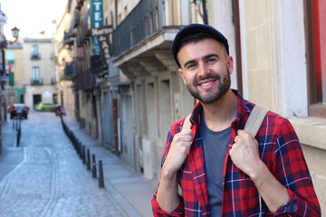 Happy young male heading to the university in Europe