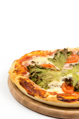 Baked round pizza with fresh lettuce and tomato with copy space