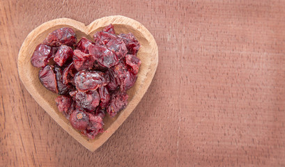 Dried cranberries on wooden background