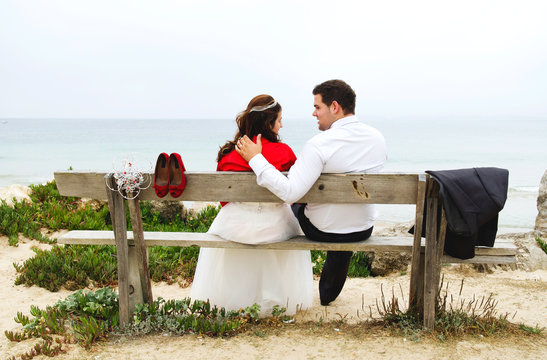 Bride and grrom dating and playing on the beach