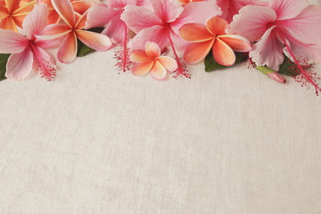 Frangipani, Plumeria, Hibiscus flowers on linen, International Women's Day background