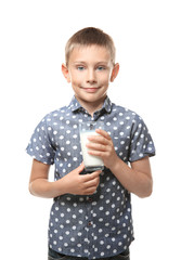 Smiling little boy holding glass of milk isolated on white