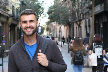 Happy young male heading to the university 