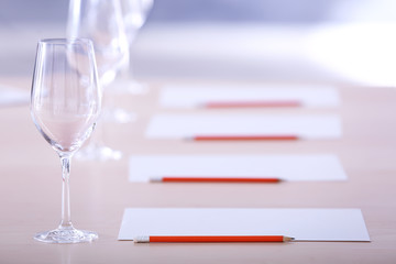 Glasses and cards prepared for wine estimating on table
