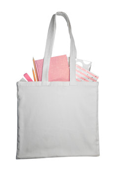 Fabric bag with stationery on white background