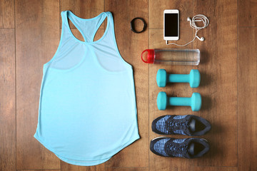 Sport clothes and equipment on wooden background