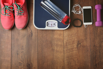 Sport sneakers and equipment on wooden background