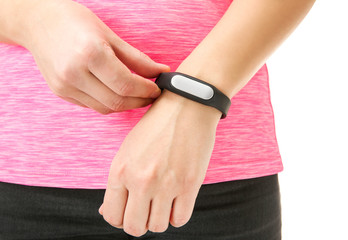 Woman using fitness tracker on white background