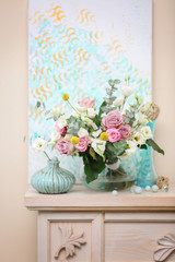 Beautiful composition with fresh flowers on mantelpiece