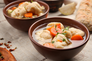 Portions of delicious chicken and dumplings on dining table