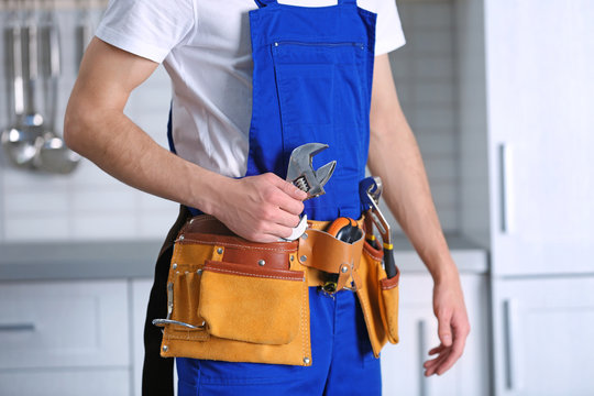 Handsome young worker in kitchen, closeup