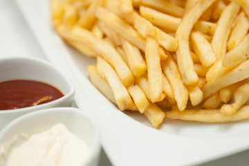 French fries in the bowl with ketchup and mayonnaise