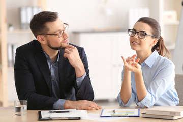 Young managers discussing issues in office