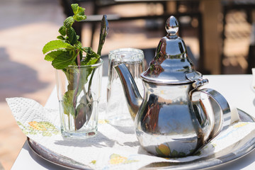 Teapot and glass with mint leaves, Morocco