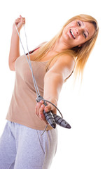 Happy blonde woman holding skipping rope