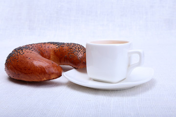 Fresh homemade muffin, cake and white cup of Cappuccino on white background.
