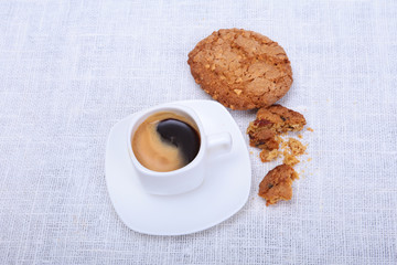 Fresh homemade muffin, cake and white cup of Cappuccino on white background.