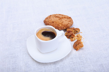 Fresh homemade muffin, cake and white cup of Cappuccino on white background.