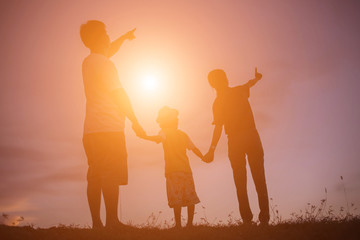 Fototapeta premium silhouette of a happy children and happy time sunset 