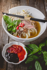 Pho Vietnamse Noodle Soup on Old Wood. Image for Food Advertise Concept