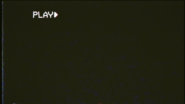 An old damaged VHS tape playing, black screen with PLAY text, 30 fps. A vintage background for videos, a retro element.
