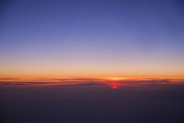Fototapeta na wymiar sunrise from horizon seen from air plane in the sky
