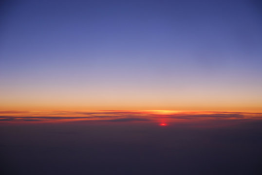 Fototapeta sunrise from horizon seen from air plane in the sky