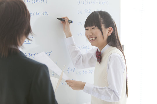 Teenage Girl Writing on Whiteboard