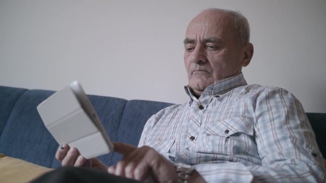 Senior man with tablet pc at home 