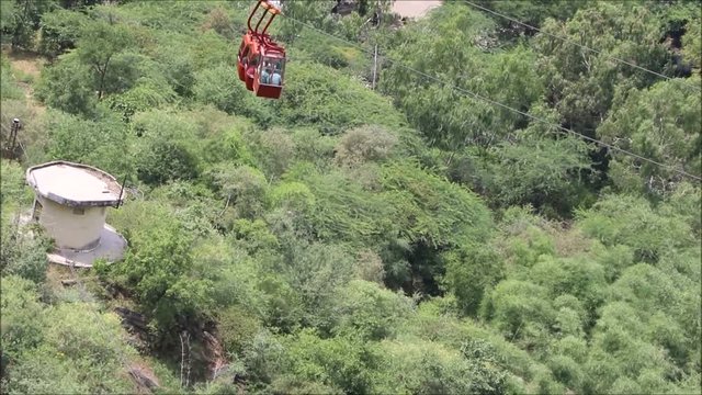 A ropeway trolley is carrying the devotees of Goddess Mansapurna Karni Mata in Udaipur from one end to another.