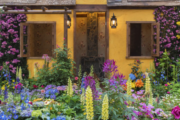 Fototapeta na wymiar Landscaped backyard of house with flower garden