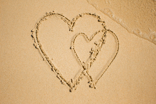 Texture of the sand at drawing the heart.