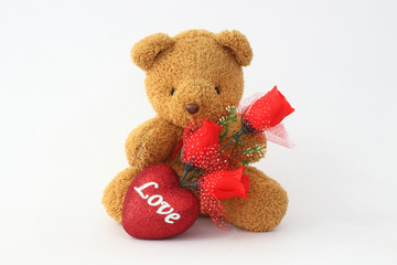 Brown teddy bears and red roses on a white background.