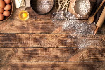 Fotobehang Meel met ingrediënten voor bakkerijproducten op houten achtergrond © kucherav