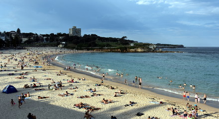 Sydney, Australia - Feb 5, 2017. People relaxing, swimming and sun bathing on Coogee beach. Located on Sydney's famous Coastal Walkway which stretches from Bondi Beach to Maroubra Beach.