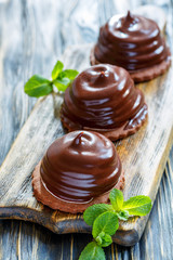 Individual cakes with souffle in chocolate glaze.
