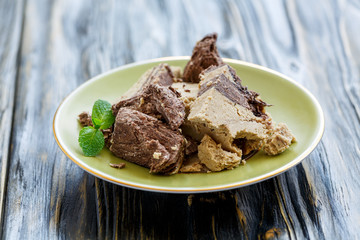 Plate with tahini halva with chocolate and mint.