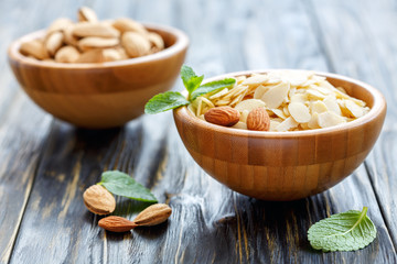 Almond flakes in a wooden bowl.