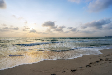 Beatiful sunset with clouds over sea and beach