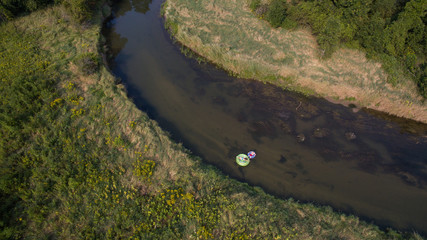Aerial photo of a couple tubing down the river