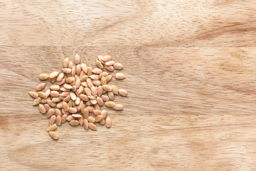 Raw cleaned watermelon seeds on a wooden background
