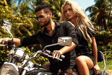 Fototapeta na wymiar Man riding on a motorcycle with girlfriend on road.
