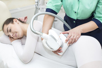 Woman is in the process at the clinic lipomassage 