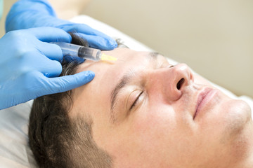 Fototapeta premium Man passes a course of mesotherapy clinic 