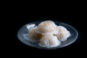 Dumpling in the glass plate on black background