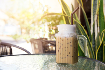 Iced Coffee Latte with Ice outdoor coffee shop with green garden.